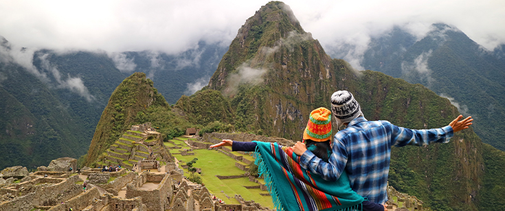 Couple looking down at Machu Picchu Couple looking down at Machu Picchu